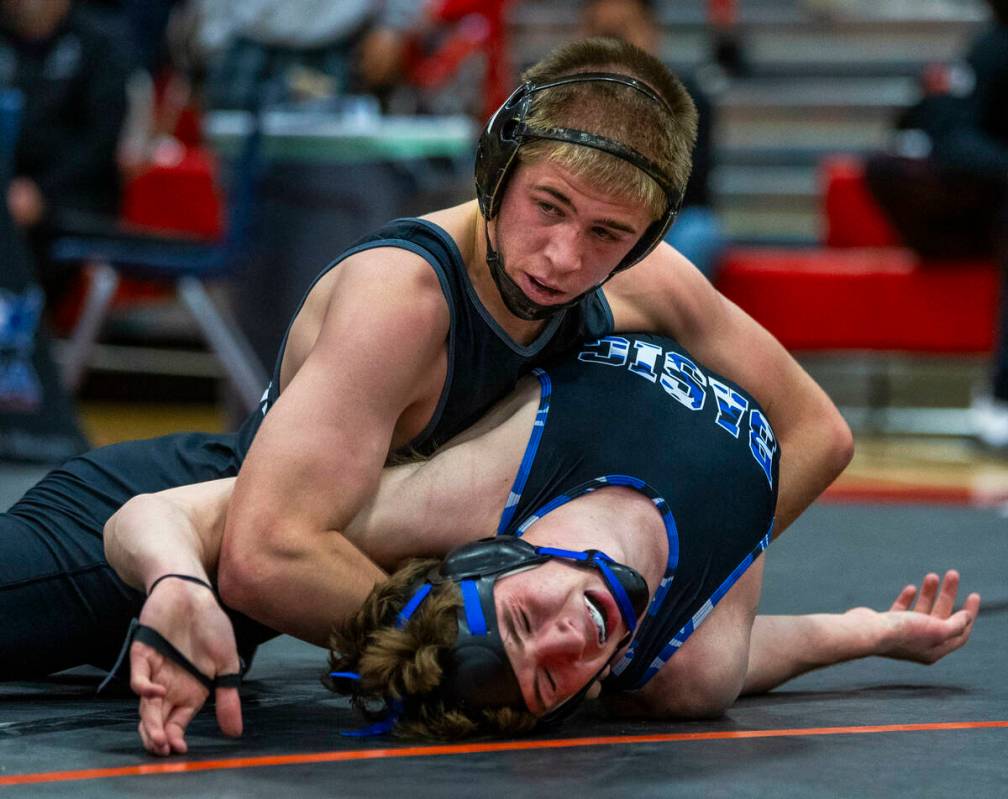 SLAM's Isaac Balden works to pin Basic's Jaxon Mackey during their 150 lb. finals match in the ...