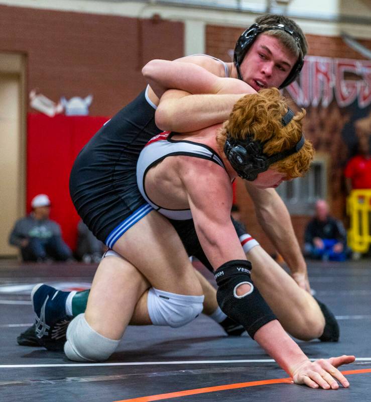 Pleasant Grove's Ian Fritz works to bring Desert Oasis' Chance Mannino down to the mat during t ...