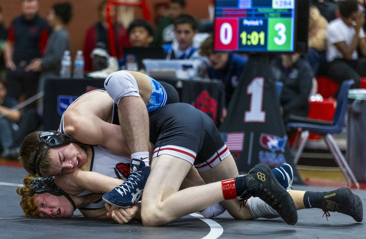 Pleasant Grove's Ian Fritz wraps up Desert Oasis' Chance Mannino for a pin attempt during their ...