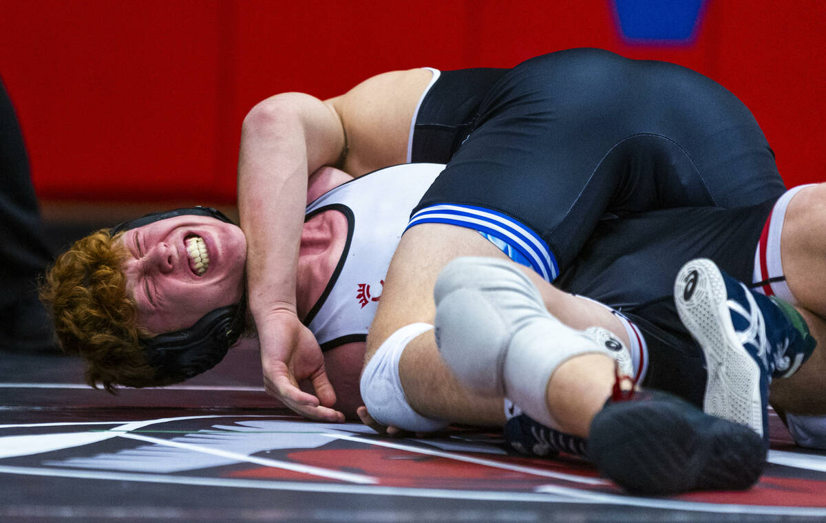 Desert Oasis' Chance Mannino winces in pain as Pleasant Grove's Ian Fritz works for the pin dur ...