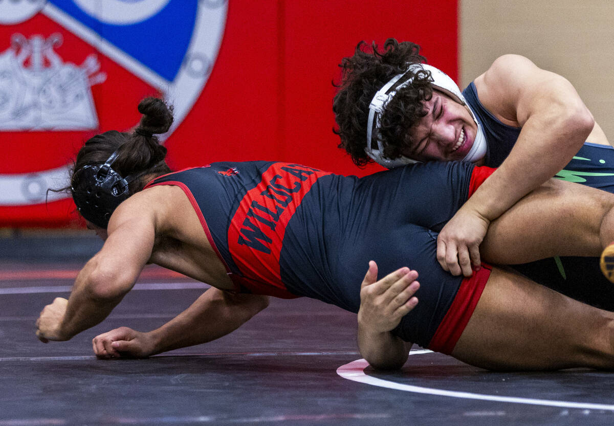 Las Vegas High's Leonard Castellanos fights to escape a hold by SLAM's Gabriel Delgado during t ...