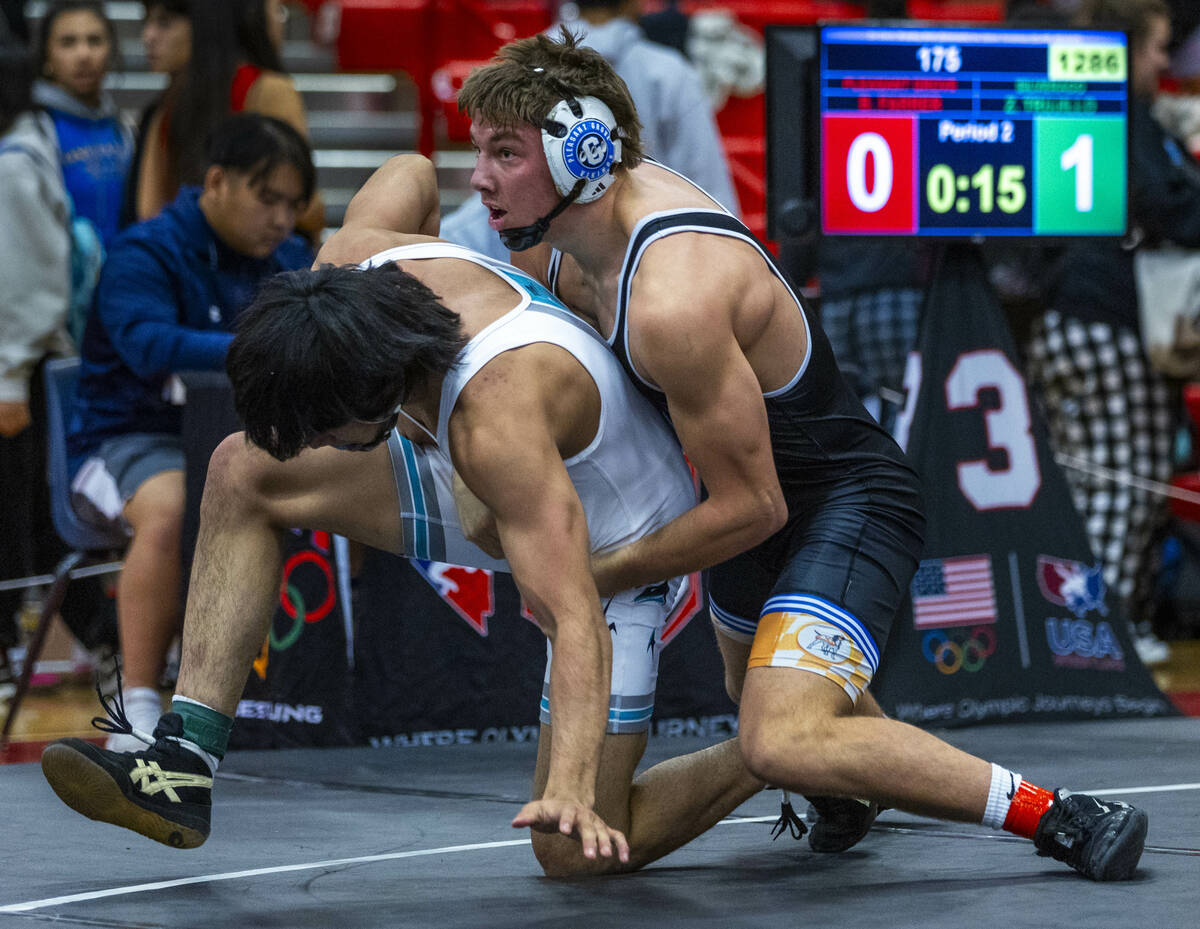 Silverado's Zyon Trujillo works to escape a hold by Pleasant Grove's Bradlee Farrer during thei ...