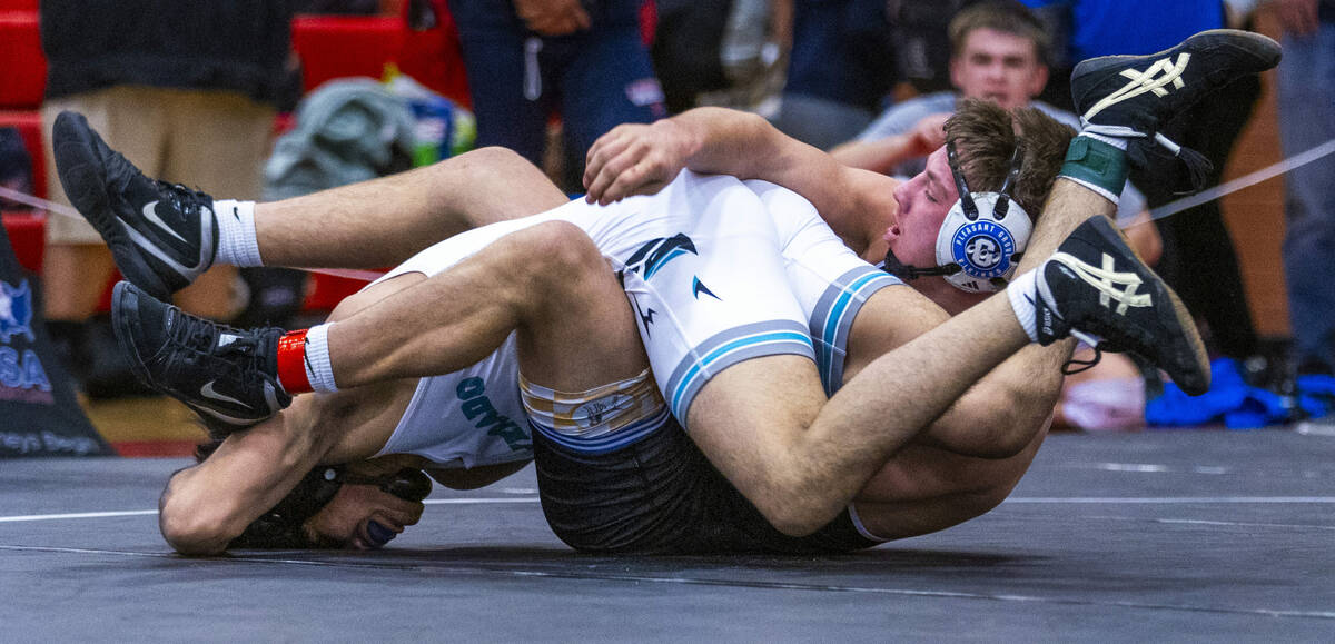 Silverado's Zyon Trujillo is driven to the mat by Pleasant Grove's Bradlee Farrer during their ...