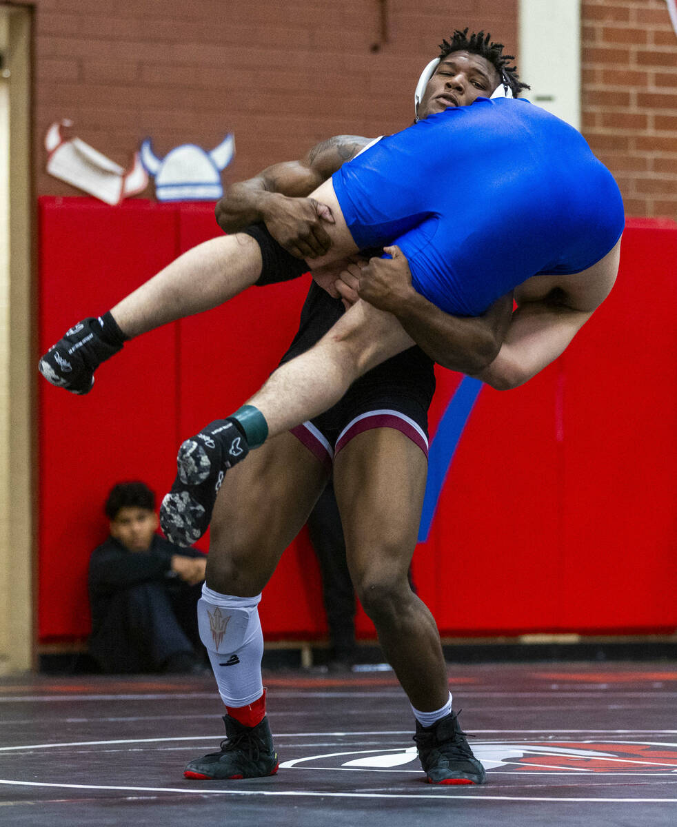 Liberty's Melvin Whitehead lifts up Desert Pines' Manuel Salazar before taking him to the mat d ...