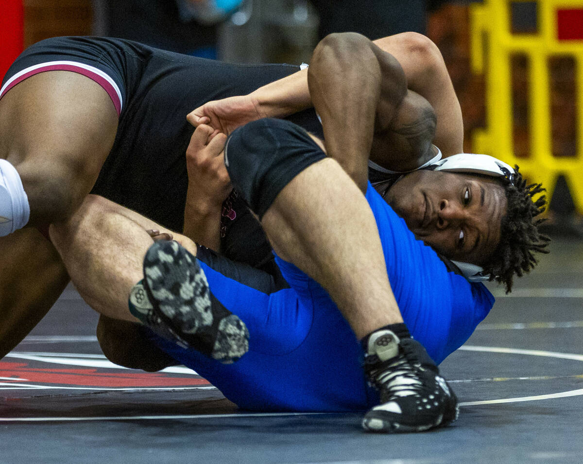 Liberty's Melvin Whitehead works to pin Desert Pines' Manuel Salazar during their 215 lb. final ...