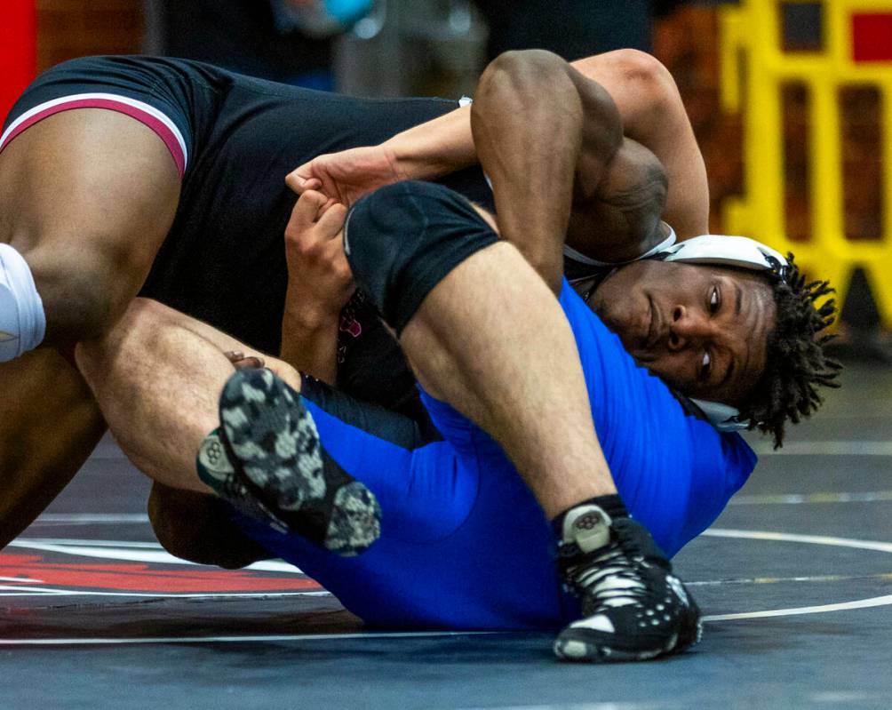 Liberty's Melvin Whitehead works to pin Desert Pines' Manuel Salazar during their 215 lb. final ...