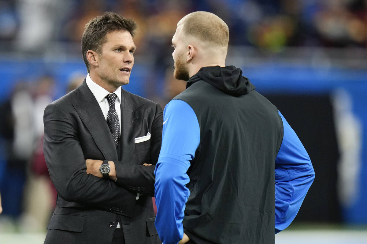 Tom Brady, left, talks with Detroit Lions defensive end Aidan Hutchinson before an NFL football ...