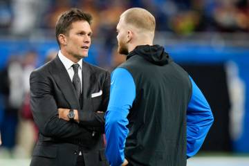 Tom Brady, left, talks with Detroit Lions defensive end Aidan Hutchinson before an NFL football ...