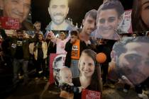 Demonstrators hold portraits of hostages held by Hamas in the Gaza Strip during a protest calli ...