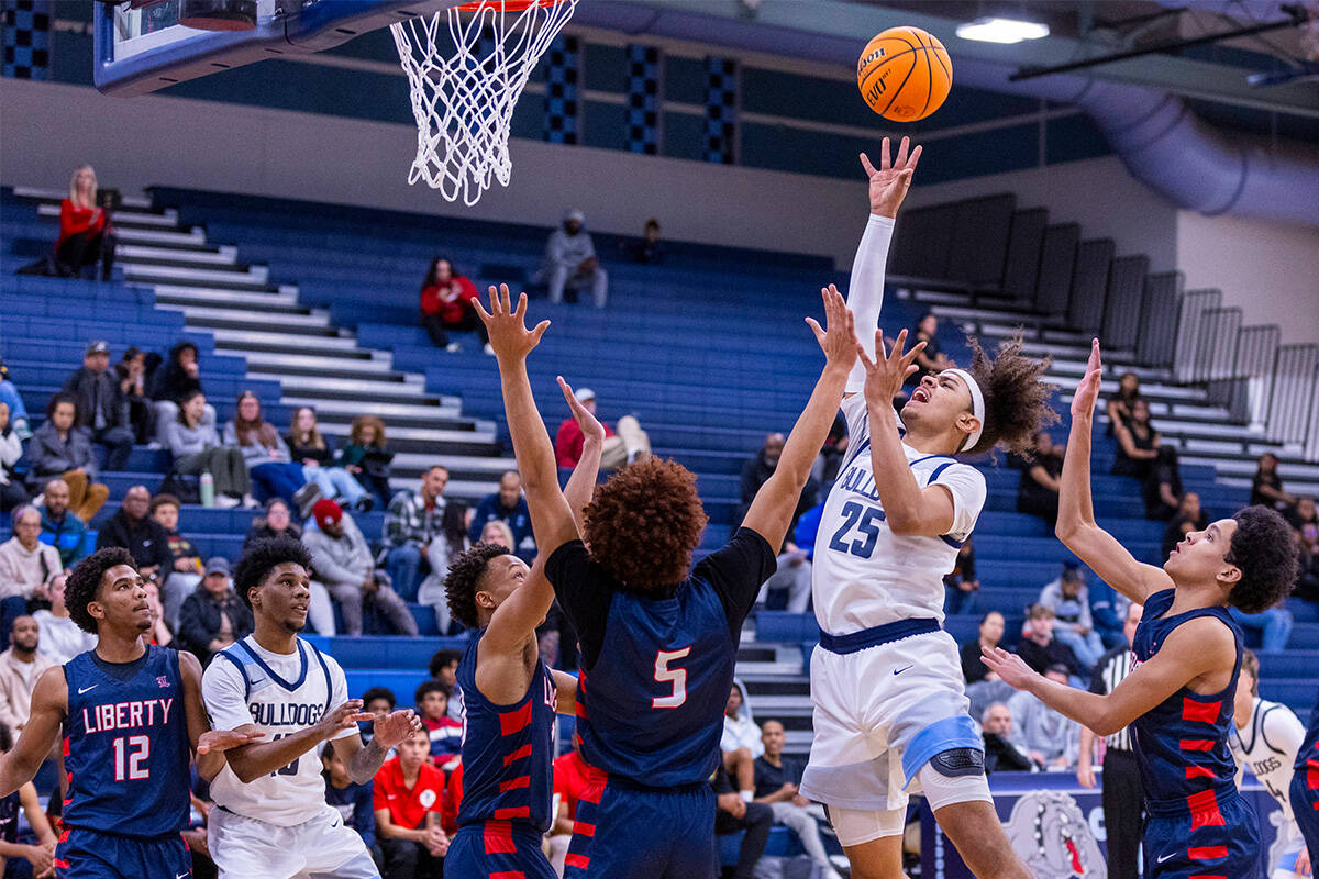 Centennial's Jayonni Durrough (25) shoots over Liberty's Dante Steward (5) during the first hal ...