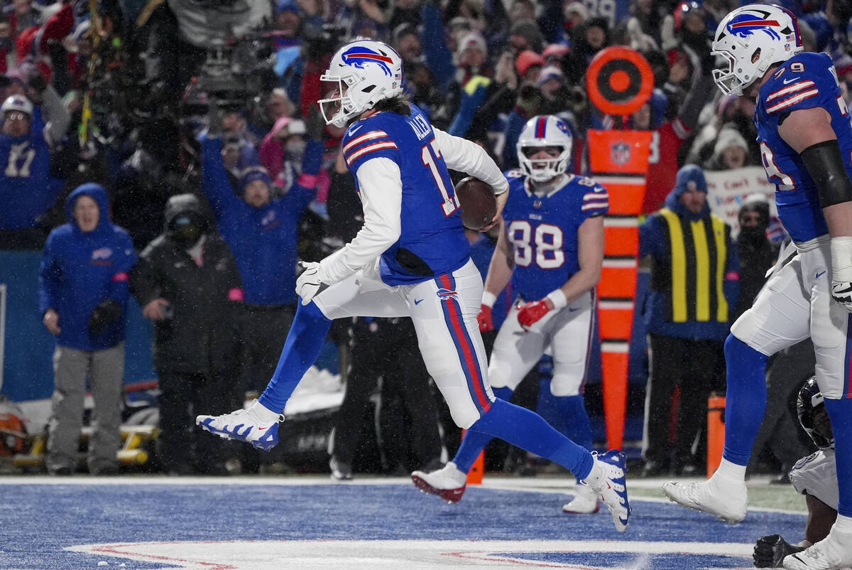 Buffalo Bills quarterback Josh Allen (17) carries the ball into the end zone to score a touchdo ...