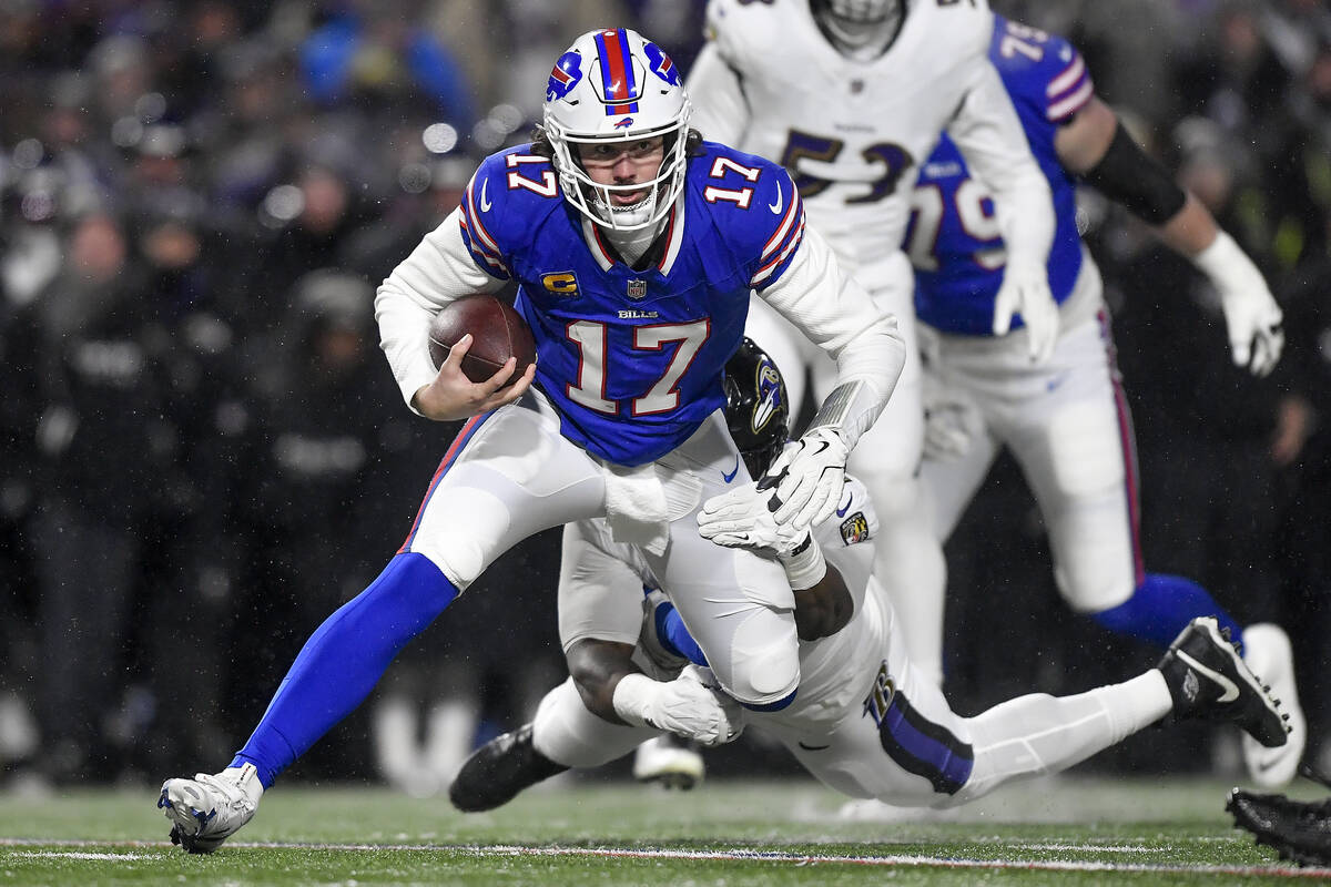 Buffalo Bills quarterback Josh Allen (17) is tackled by Baltimore Ravens defensive tackle Nnamd ...