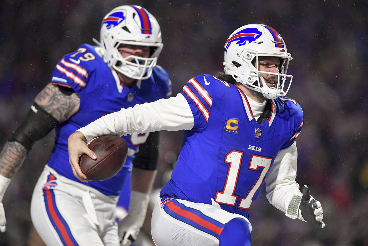 Buffalo Bills quarterback Josh Allen (17) carries the ball into the end zone to score a touchdo ...