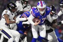 Buffalo Bills quarterback Josh Allen (17) carries the ball into the end zone to score a touchdo ...