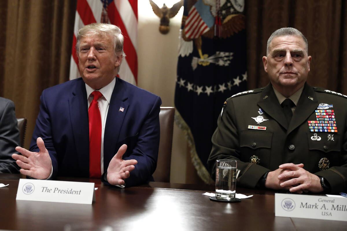 FILE - President Donald Trump speaks as the Chairman of the Joint Chiefs of Staff Gen. Mark Mil ...