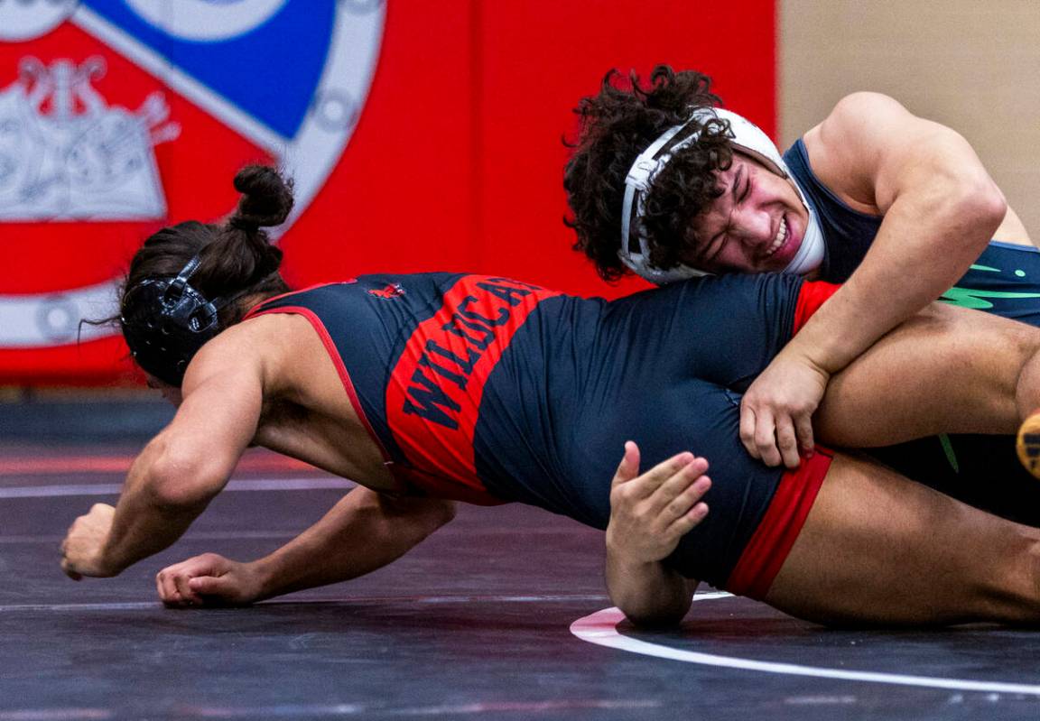 Las Vegas High's Leonard Castellanos fights to escape a hold by SLAM's Gabriel Delgado during t ...