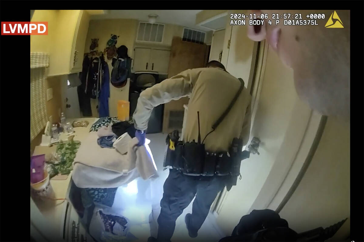 A screenshot from Metropolitan Police Department body camera footage shows officers examining a ...