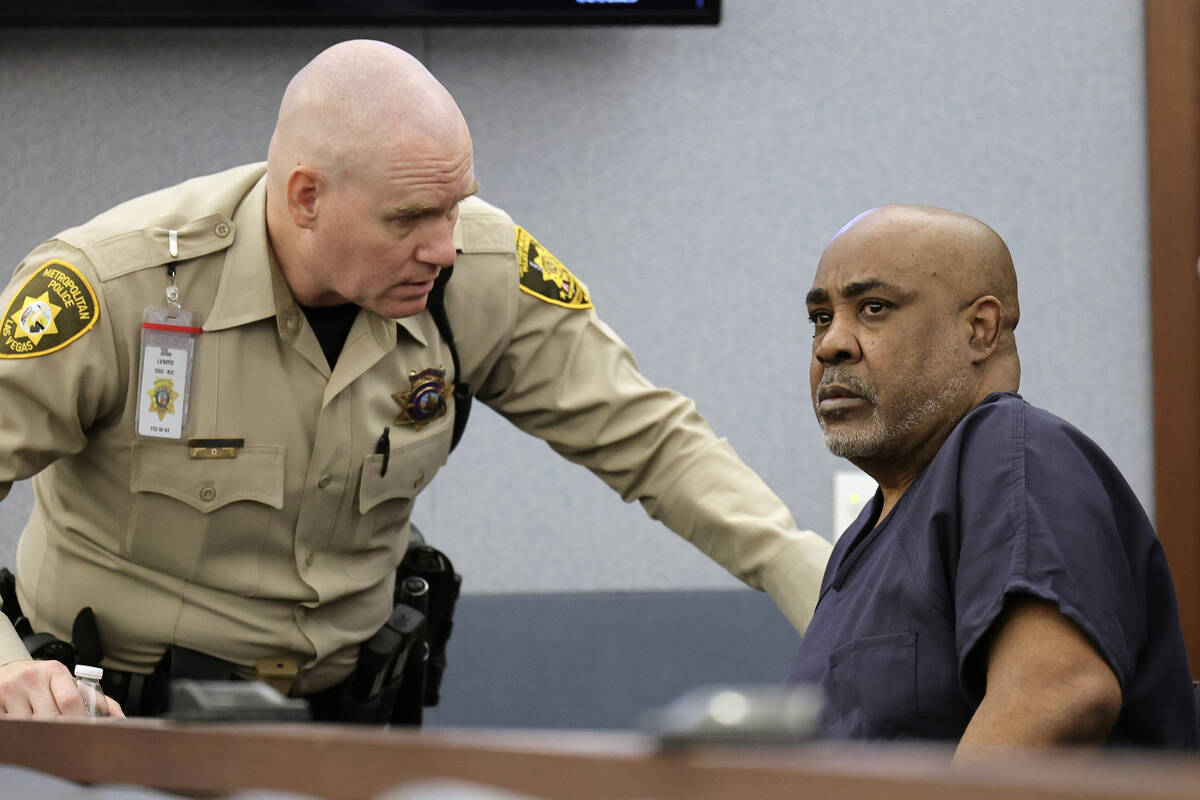 A Las Vegas Metropolitan Police officer talks with Duane Davis as he appears in Clark County Di ...