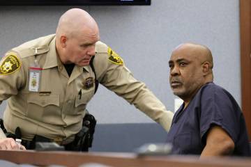 A Las Vegas Metropolitan Police officer talks with Duane Davis as he appears in Clark County Di ...