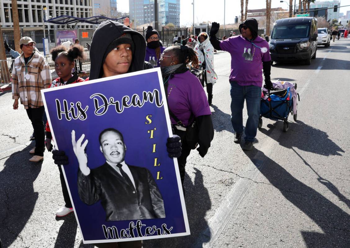 Praise Boykin, 11, with Greater New Jerusalem church marches the 43rd annual Martin Luther King ...