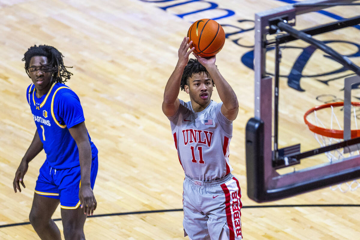 UNLV guard Dedan Thomas Jr. (11) gets off a jumps shot past San Jose State Spartans guard Will ...