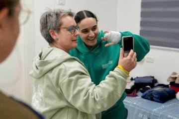 In this photo released by the Israeli Army, Emily Damari, right, and her mother Mandy use a sma ...