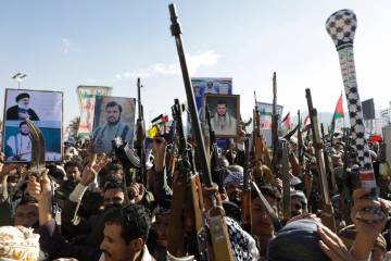 Houthi supporters raise their machine guns during an anti-Israel rally in Sanaa, Yemen, Friday, ...