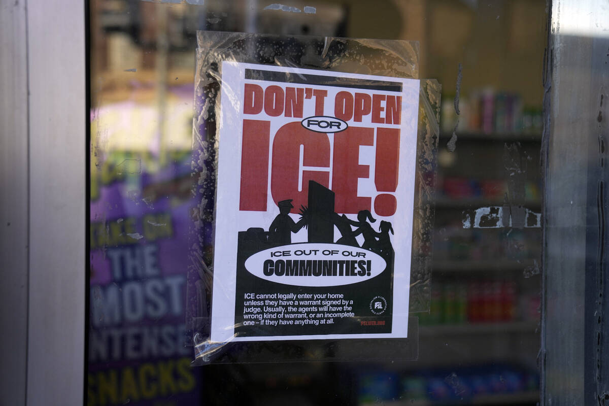 A sign regarding the U.S. Immigration and Customs Enforcement is posted on the window of a corn ...