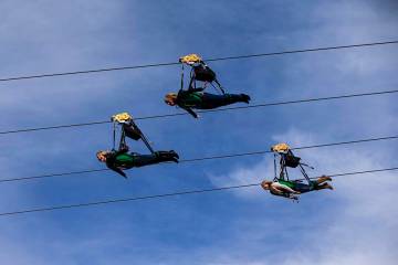 People react as they take off from the Slotzilla Zipline on Fremont Street in downtown Las Vega ...