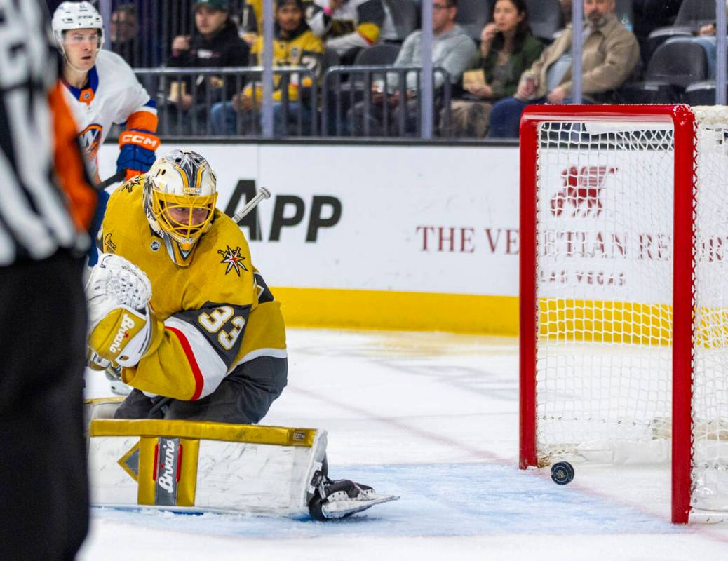 Golden Knights goaltender Adin Hill (33) watches as the puck rolls into the net against the New ...