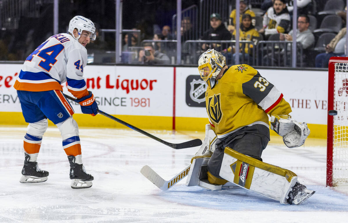 New York Islanders center Jean-Gabriel Pageau (44) slips a puck past Golden Knights goaltender ...