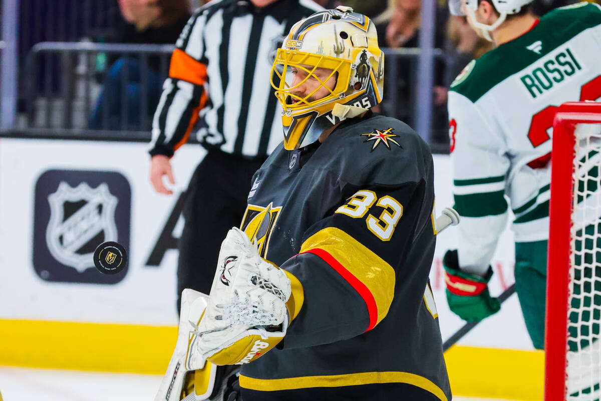 Golden Knights goaltender Adin Hill (33) tosses the puck away after a save during an NHL hockey ...