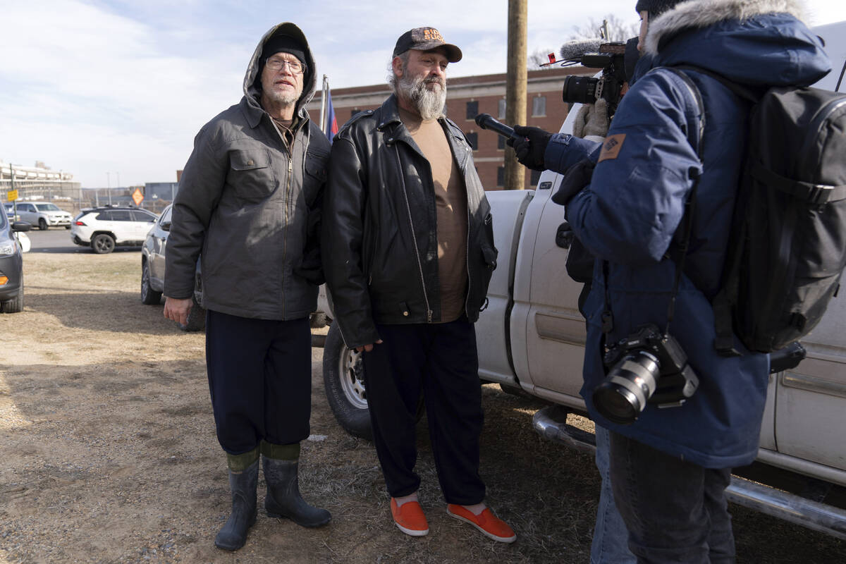 Supporters of President Donald Trump, Kevin Loftus, left and William Sarsfield III, who were co ...