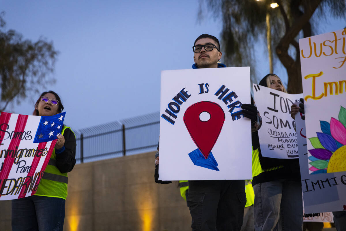 Make the Road Nevada political organizer Marco R. Holds up a sign during a rally against newly ...