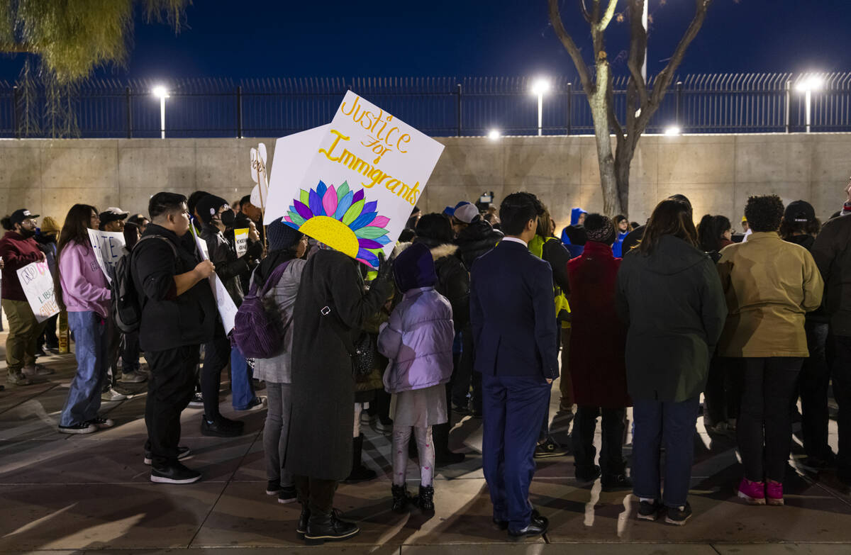 People listen to a speaker during a rally against newly established immigration policies from P ...