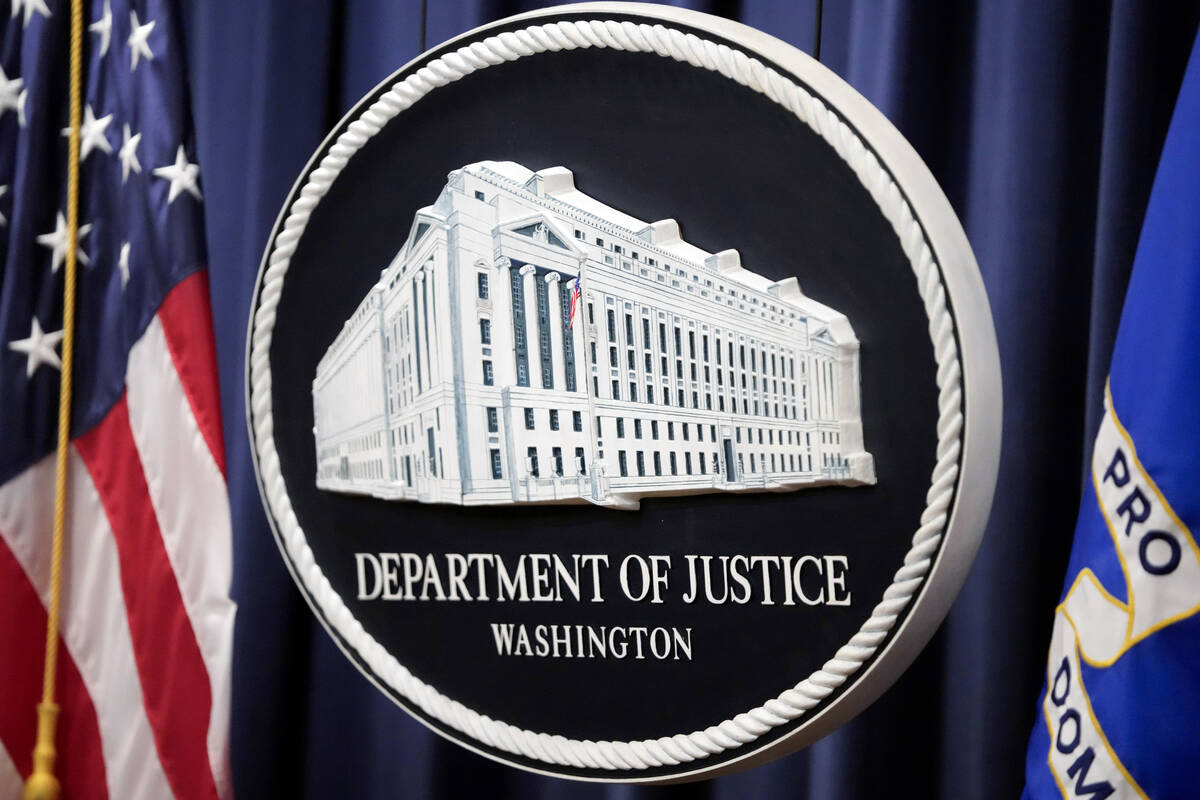 The logo for the Justice Department is seen before a news conference at the Department of Justi ...