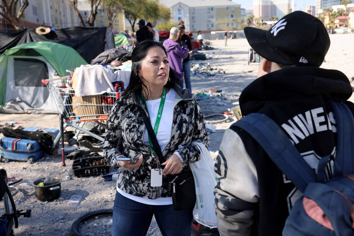 FILE - Brenda Barnes, Clark County social service assistant manager, surveys a person who decli ...