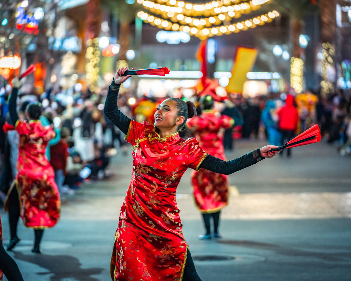 The colorful parade, which this year celebrates the Year of the Snake, features fan dancers, st ...