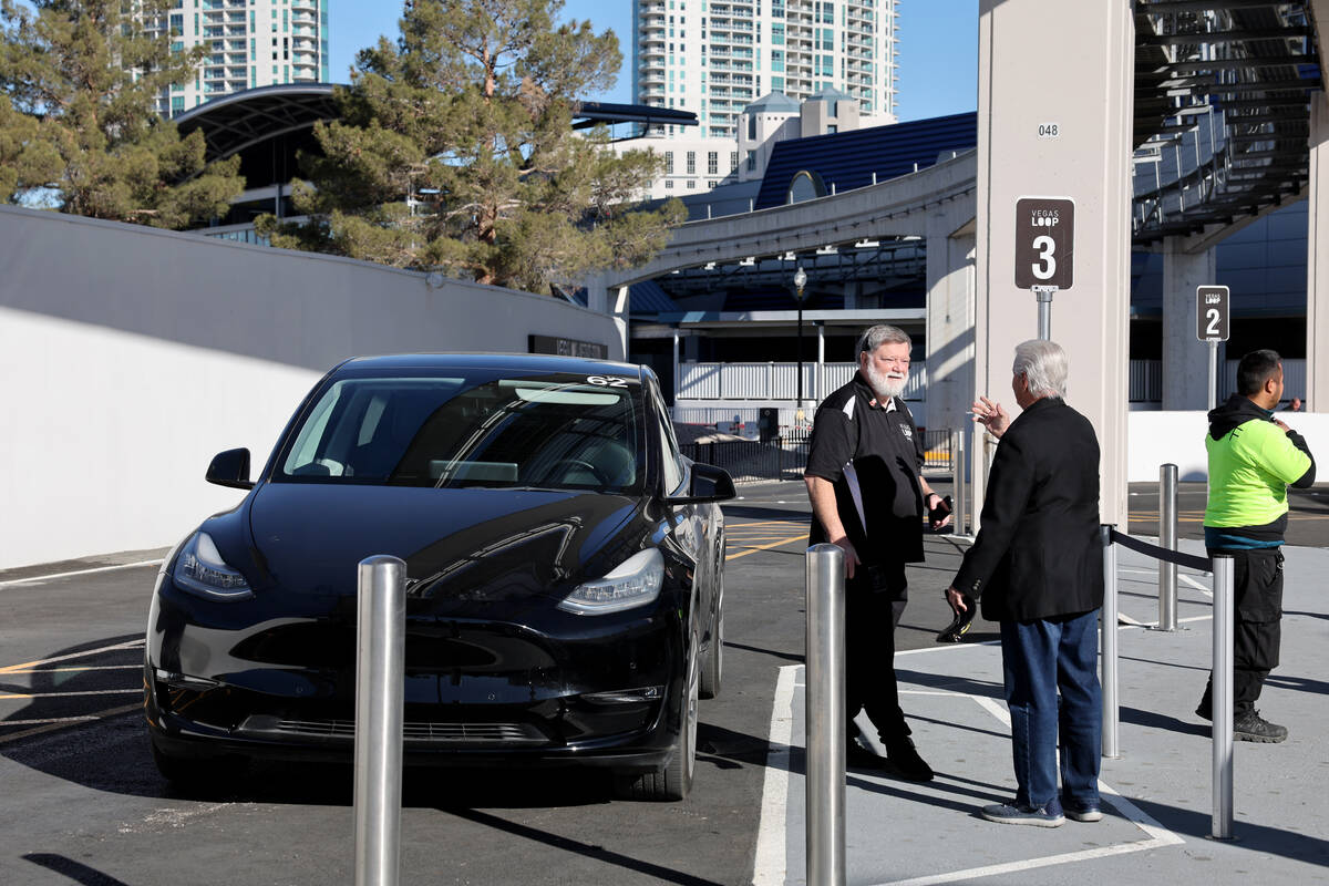 A driver talks to a passenger during the opening of the Vegas Loop Westgate Station Wednesday, ...