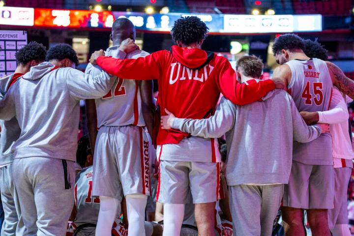 UNLV players come together on a time out against the Wyoming Cowboys during the second half of ...