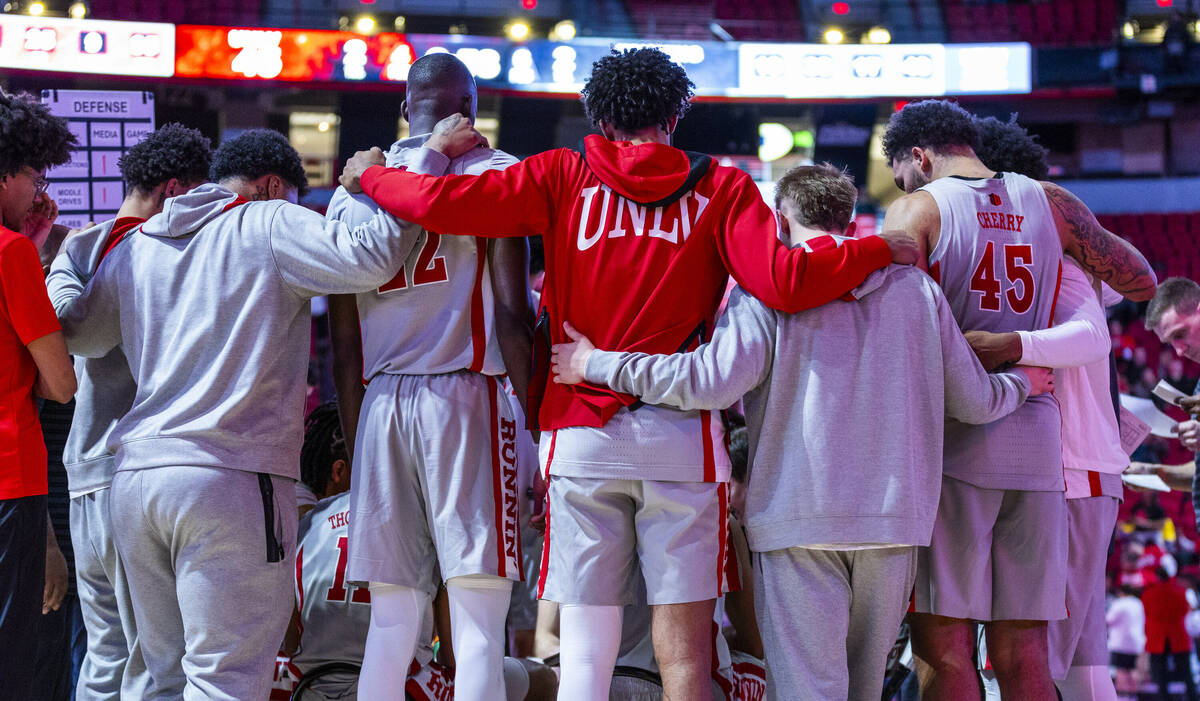 UNLV players come together on a time out against the Wyoming Cowboys during the second half of ...