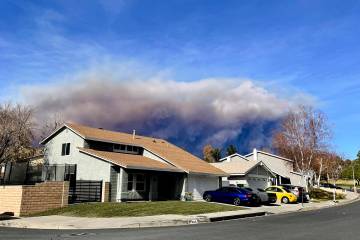 A large plume of smoke caused by the Hughes Fire rises from Castaic Lake as seen from a neighbo ...