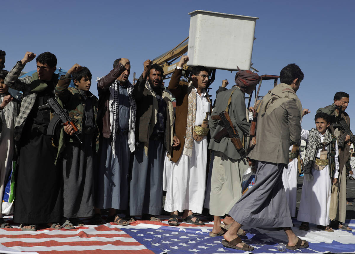 Houthi supporters step on an American flag during an anti-U.S and Israel rally in Sanaa, Yemen, ...