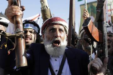 A Houthi supporter shouts slogans during during an anti-U.S and Israel rally in Sanaa, Yemen, F ...