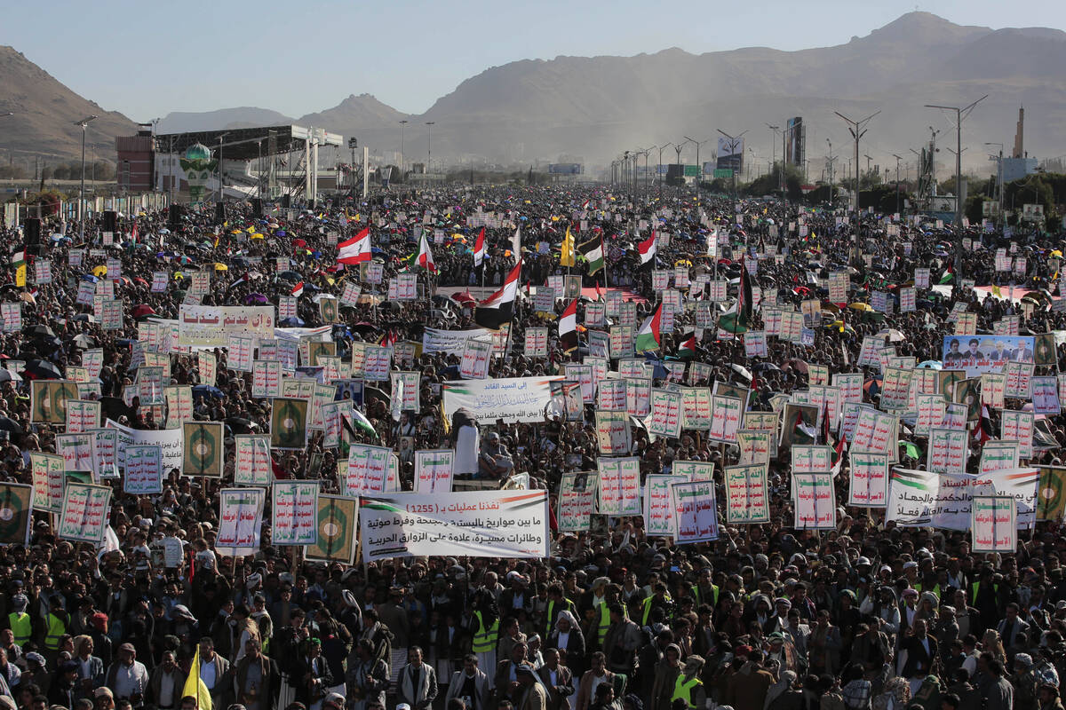 Thousands of Houthi supporters raise banners during an anti-U.S and Israel rally in Sanaa, Yeme ...