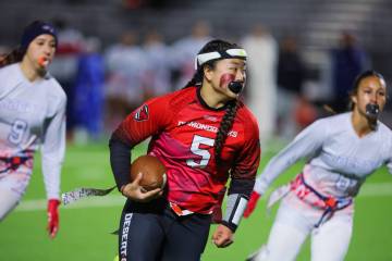 Desert Oasis quarterback Akemi Higa scrambles during a flag football game between Liberty and D ...