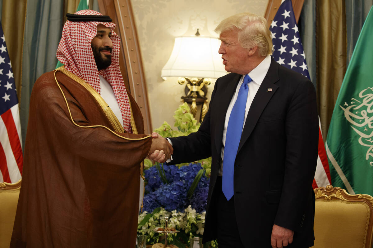 FILE- President Donald Trump shakes hands with Saudi Deputy Crown Prince and Defense Minister M ...