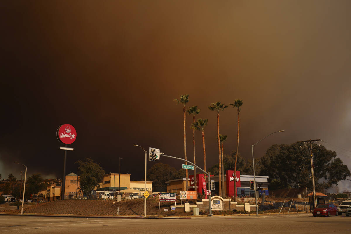 Smoke fills the sky during a wildfire on Wednesday, Jan. 22, 2025 in Castaic, Calif. (AP Photo/ ...