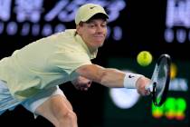 Jannik Sinner of Italy plays a backhand return to Alex de Minaur of Australia during their quar ...