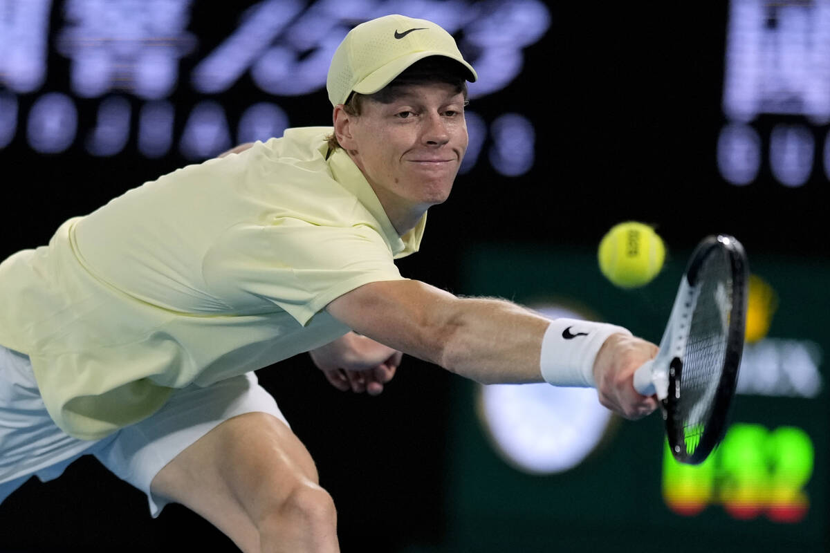 Jannik Sinner of Italy plays a backhand return to Alex de Minaur of Australia during their quar ...